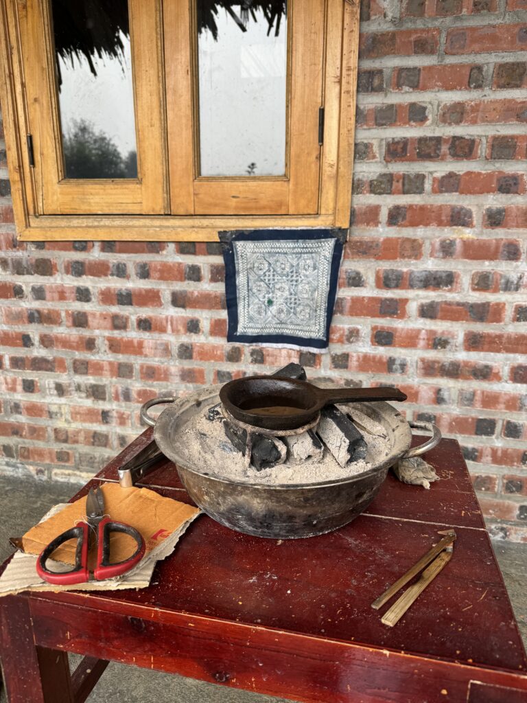 Indigo Batik Workshop setup with hot wax melting over a fire