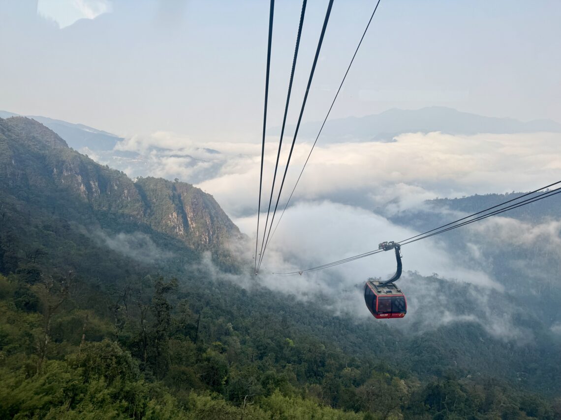 cable car over sapa mountains fog and rice fields