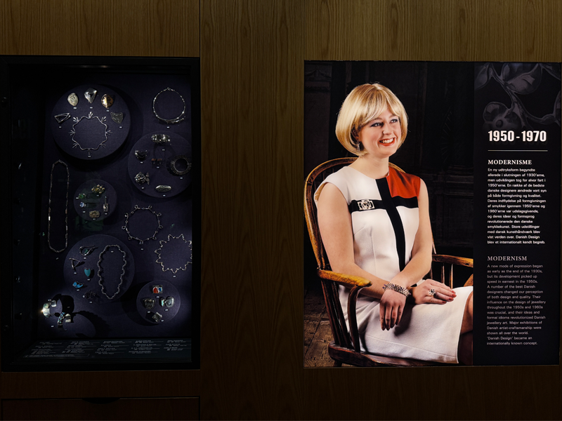 1950-1970 jewellery on a model and next to it examples in a exhibit