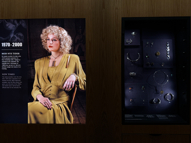 1970-2000 jewellery on a model and next to it examples in a exhibit